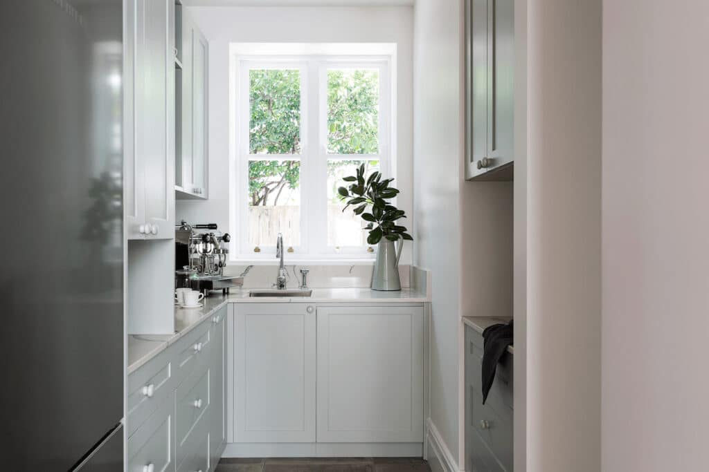 White Cabinets With Plant On Top — Windows & Doors in Central Coast, NSW