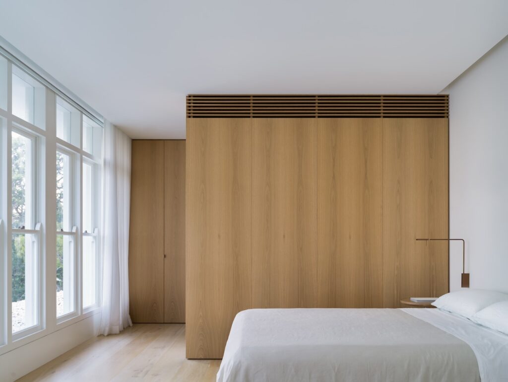 Wooden Cabinet And White Bed — Windows & Doors in Central Coast, NSW