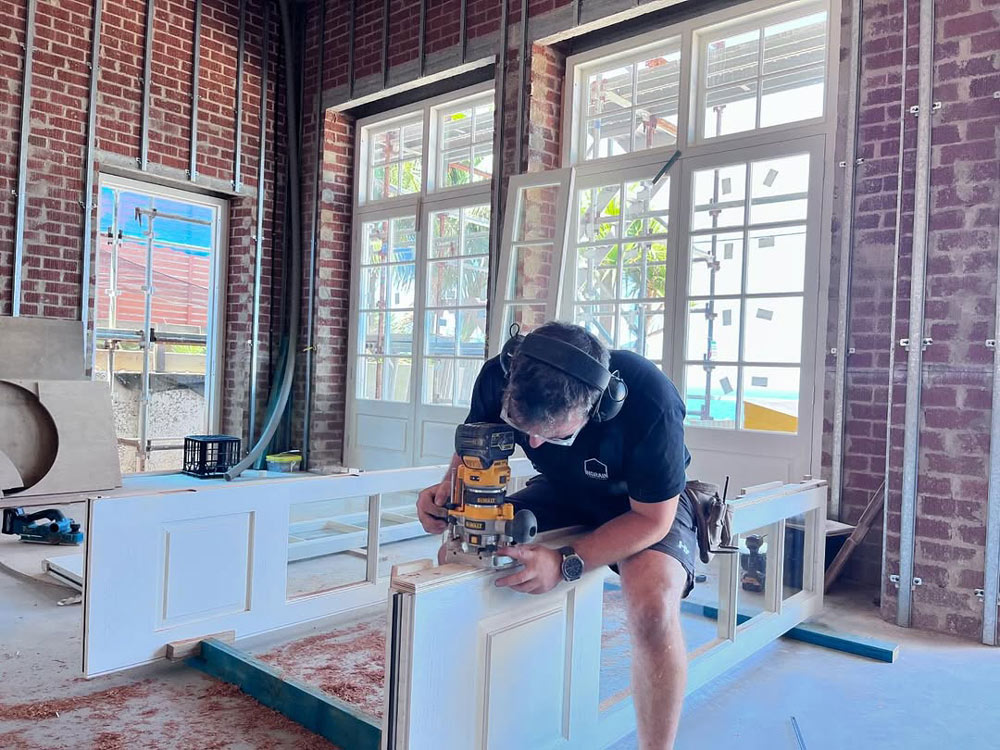 Craftsman assembling custom windows Sydney project in a professional joinery workshop
