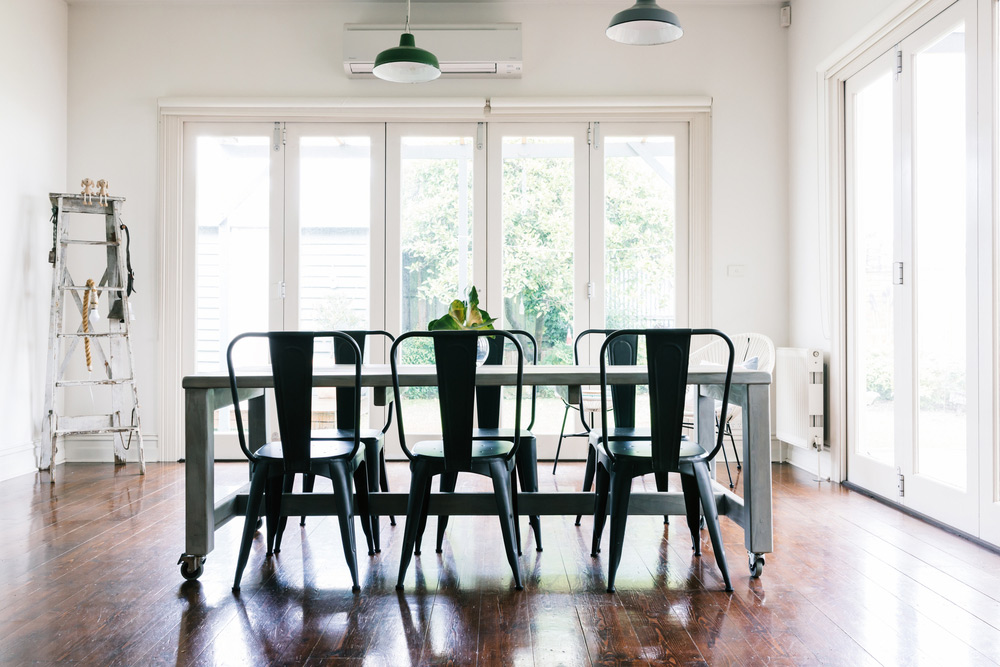 White custom bifold doors Sydney enhancing natural light and connecting indoor and outdoor spaces.
